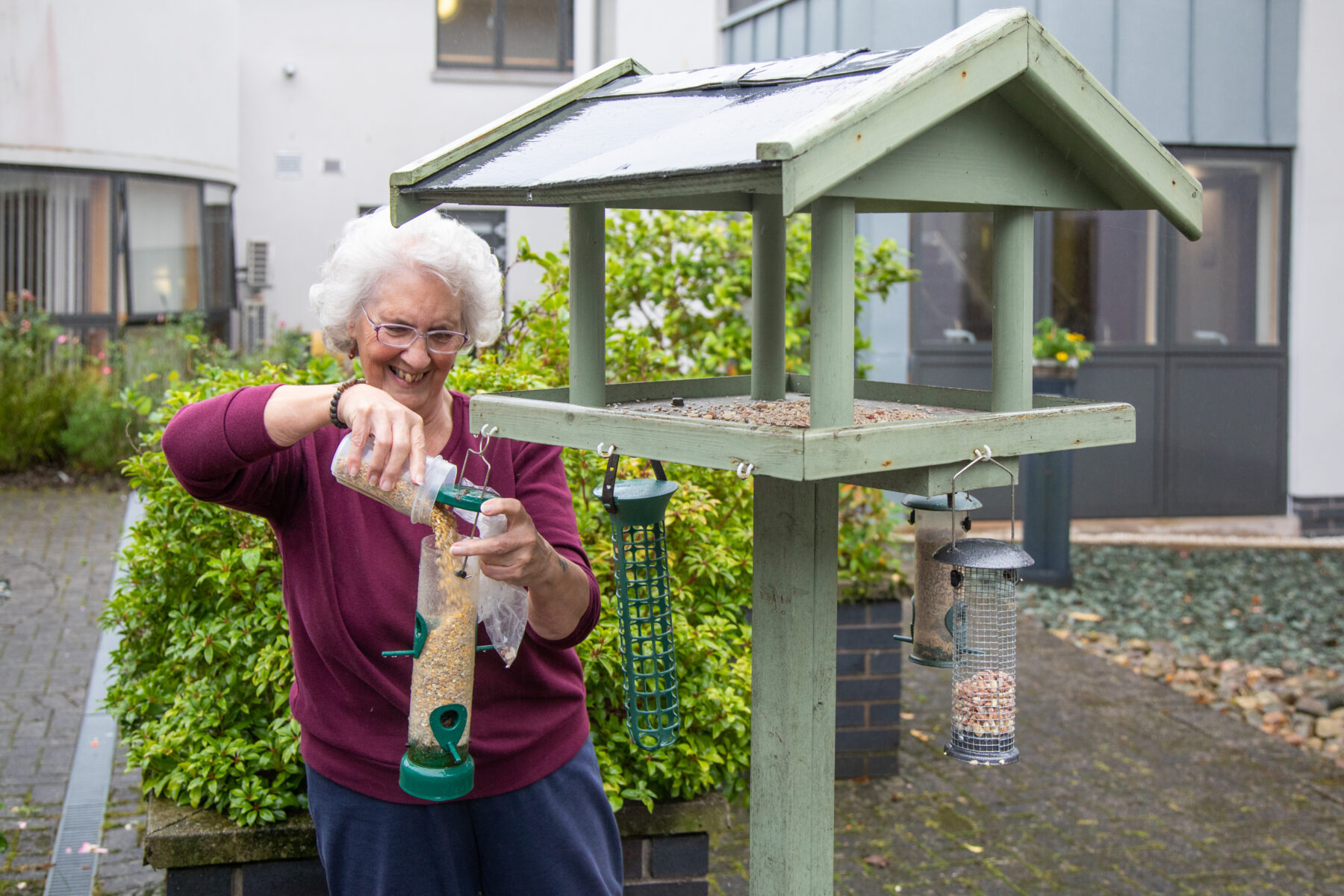 One of the Awel y Coleg residents feeding the birds in the garden