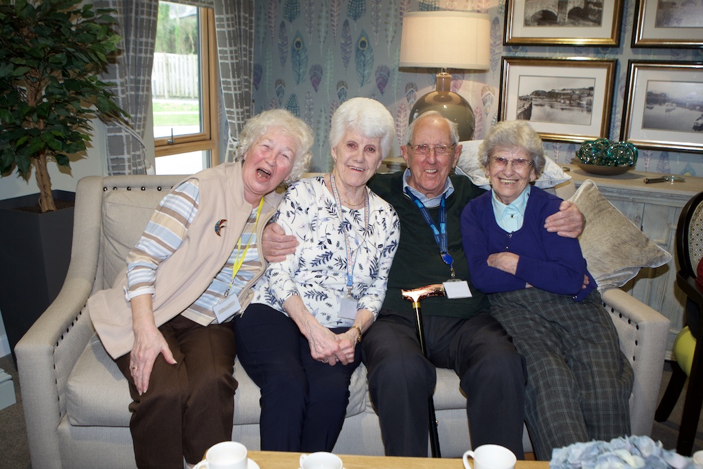 Four Hafod y Gest residents on a sofa smiling