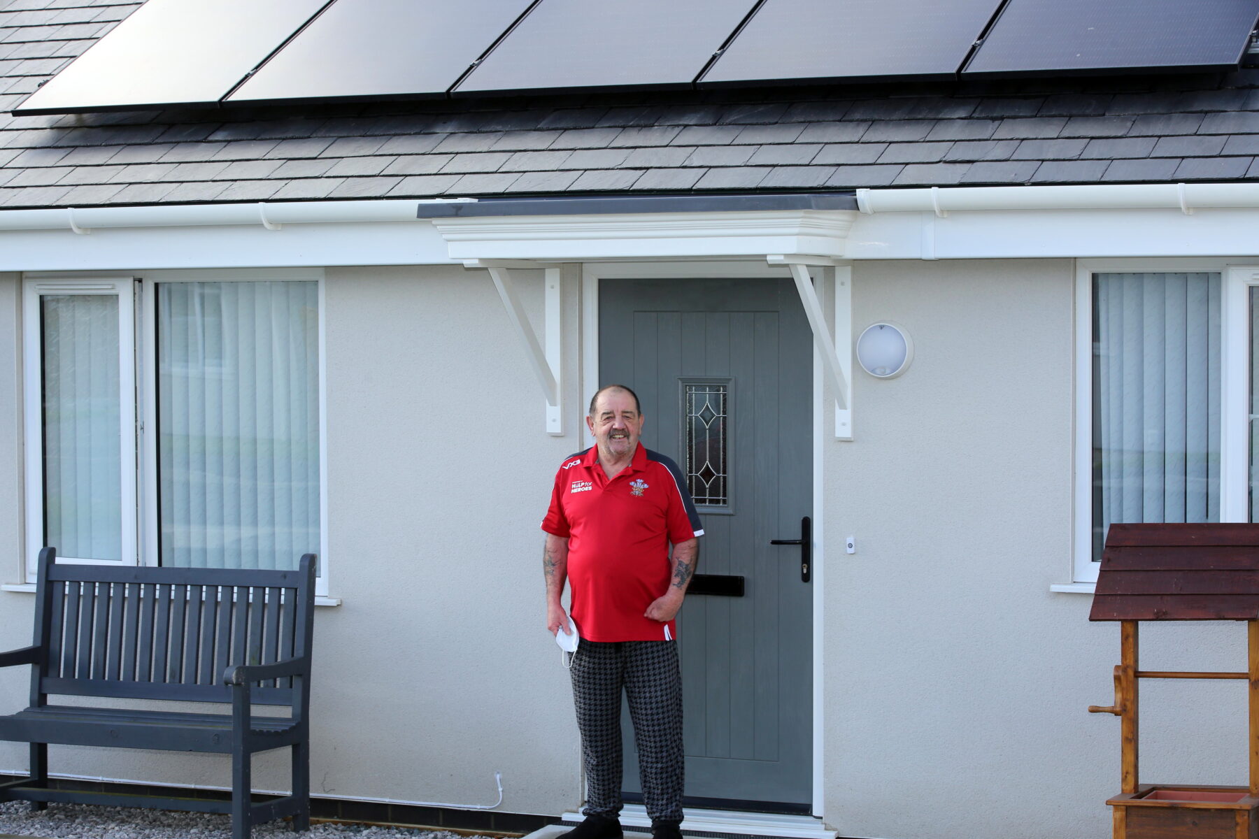 Terence Thomas outside his new Grwp Cynefin home in Llain Delyn, Gwalchmai