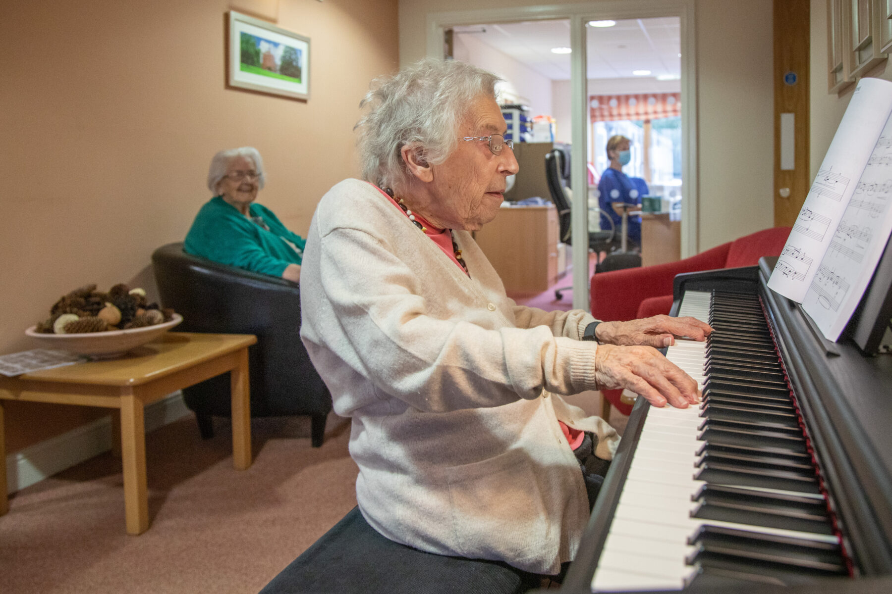 One of the Llys Awelon residents playing the piano